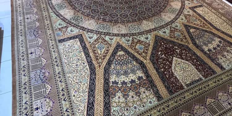 Hand-knotted Qum pure silk carpet laid out on the Al Malakia showroom floor in Sharjah