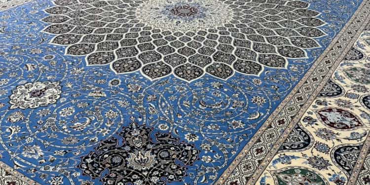 Hand-knotted blue Nain wool and silk carpet on the Al Malakia showroom floor, available to Abu Dhabi customers with free delivery