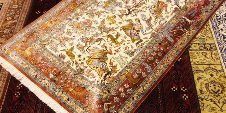 Hand-knotted Persian carpets layered on the floor of the Al Malakia showroom in the Central Souq, Sharjah